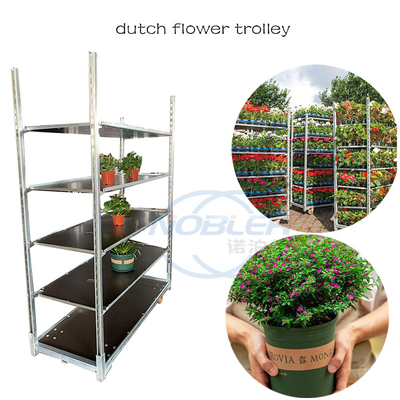 車輪が付いているデンマークの花のトロリーCcの植物の棚によっては輸送のトロリーが開花する